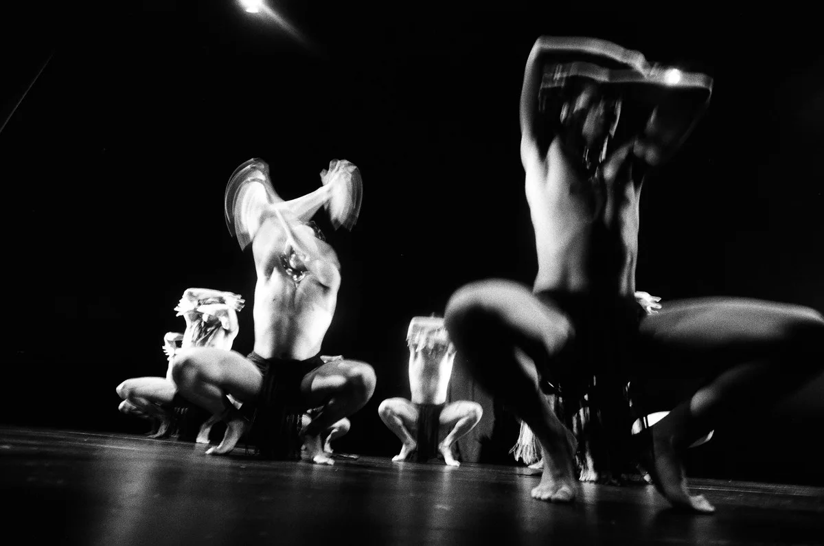 Layered photographic artwork showing a group of performers